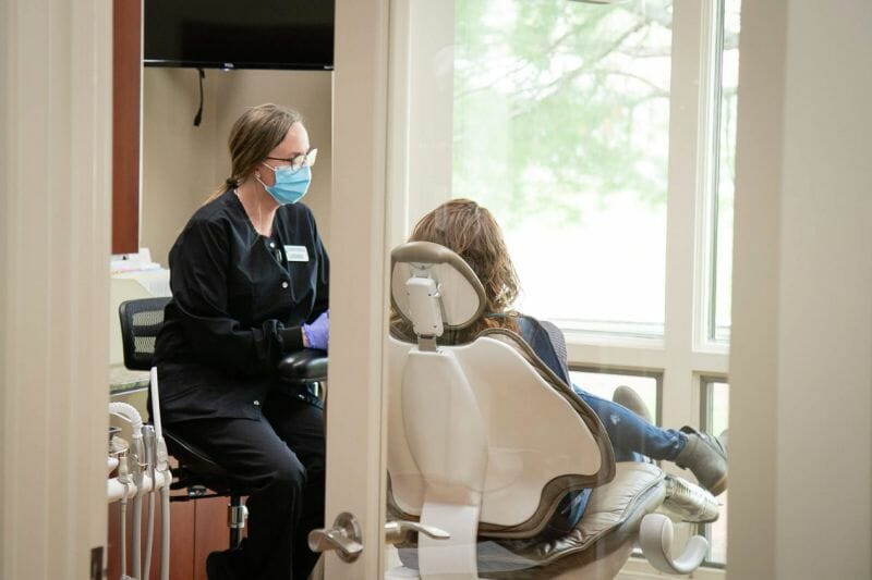 Woman at the dentist being treated.
